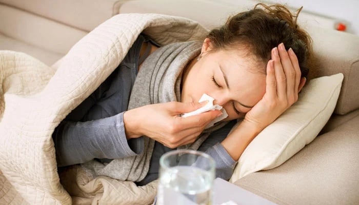 An influenza-affected patient lying on a couch. — Social media @medlineplus/File
