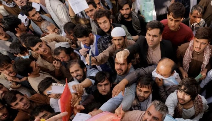 Afghans gather outside the passport office in Kabul in October 2021, two months after the Taliban seized power in Afghanistan. — Reuters/File