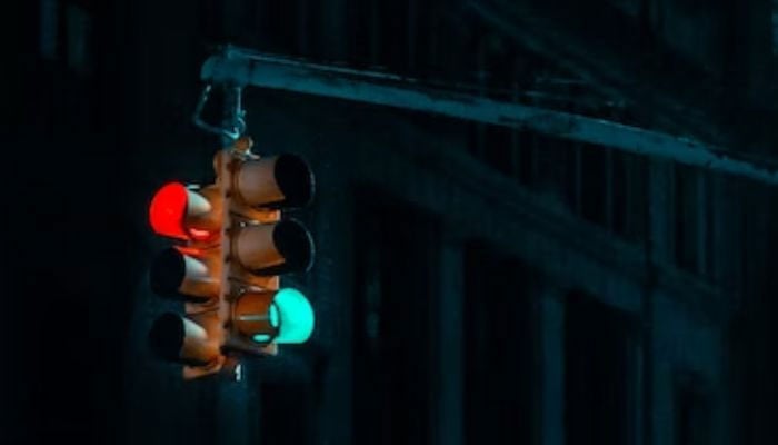 Image shows traffic lights at night.— Unsplash/File