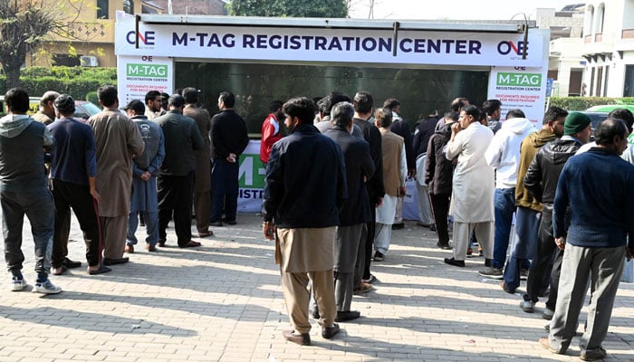 People stand in a queue to install E-tags/M-tags for their vehicles at Kachnar Park in the Federal Capital on November 21, 2025. — APP