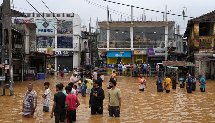 People gather at an area affected by floods, following heavy rainfall in Malwana, Sri Lanka, November 29, 2025.—Reuters