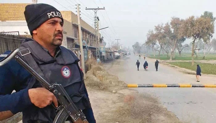 A policeman stands guard near the site of an attack in KP. — AFP/File