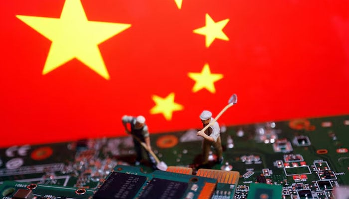 Worker miniatures are placed among the flags of China and printed circuit boards with semiconductor chips, in this illustration picture taken July 5, 2023. — Reuters