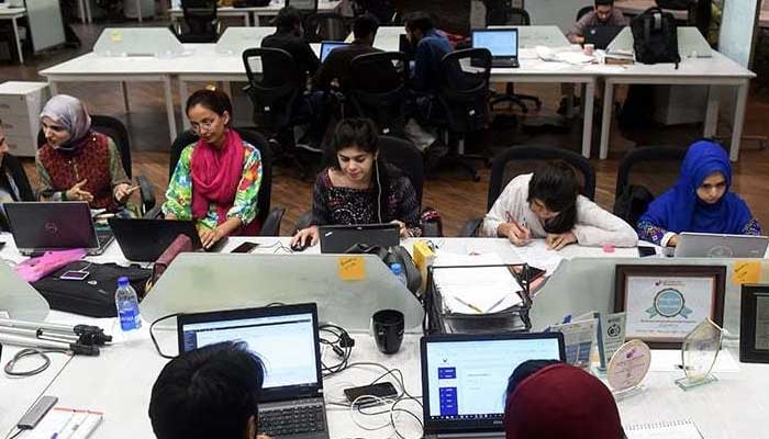 Young women work at their stations at the National Incubation Centre (NIC), a start-up incubator. — AFP/File