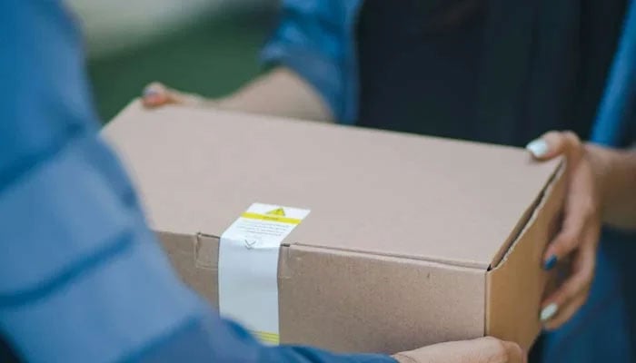 The representational image shows a delivery man giving a package. — Unsplash/File