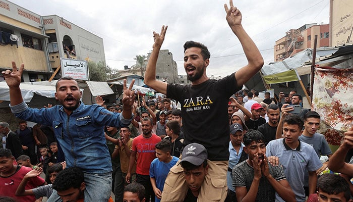 Palestinians celebrate, after US President Donald Trump announced that Israel and Hamas agreed on the first phase of a Gaza ceasefire, in Khan Younis in the southern Gaza Strip October 9, 2025. — Reuters