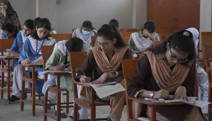 Pakistani students of Secondary schools solving papers during the annual exam of SSC Part-I at the examination centre, in Karachi on May 8, 2023. — Online