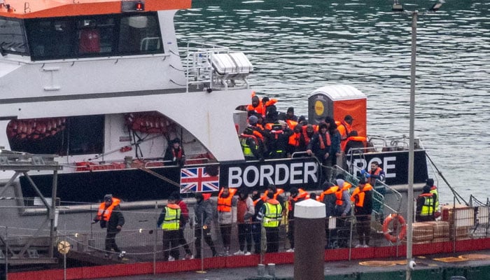 Migrants disembark from a British Border Force vessel as they arrive at the Port of Dover, in Dover, Britain, December 29, 2024.—Reuters