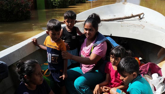 Women and children ride on a boat after being rescued from a flooded area, following Cyclone Ditwah in Kelaniya, Sri Lanka, November 30, 2025. — Reuters