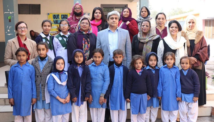 Secretary, Ministry of Federal Education and Professional Training, Nadeem Mahbub, in a group photo with students after the inauguration of the third phase of the School Meal Programme during a visit to Islamabad Model School for Girls (I-X), Mohra Noor on December 5, 2025. — Facebook@mofept