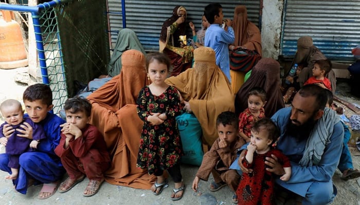 An Afghan family waiting to cross the main Afghanistan-Pakistan land border crossing in Torkham, September 15, 2023. — Reuters