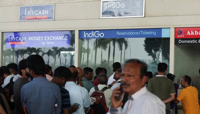 Passengers wait outside the Indigo airlines ticketing counter at the Chhatrapati Shivaji Maharaj International Airport, after several IndiGo airlines flights were cancelled, in Mumbai, India, December 5, 2025.—Reuters