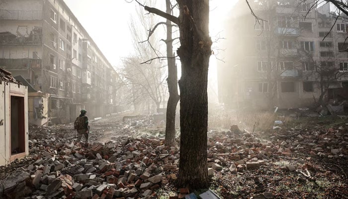 A Ukrainian serviceman walks near apartment buildings damaged by a Russian military strike, amid Russias attack on Ukraine, in the frontline town of Kostiantynivka in Donetsk region, Ukraine November 15, 2025.—Reuters