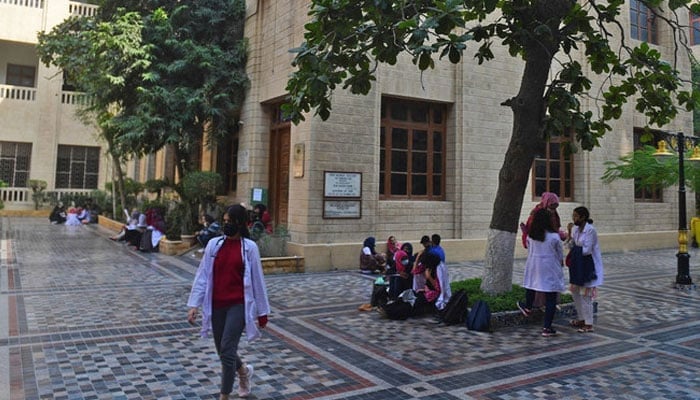In this picture taken on January 13, 2022, students gather at a yard of the Dow University of Health Sciences, in Karachi.— AFP