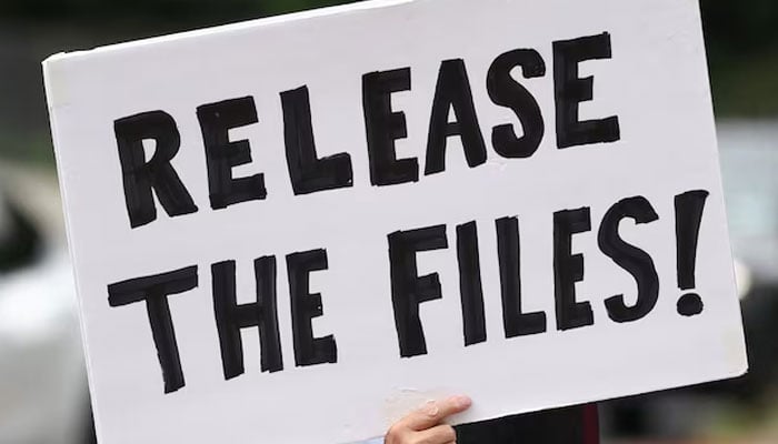 A protester calling for a release of the Epstein files holds a sign. —Reuters/File