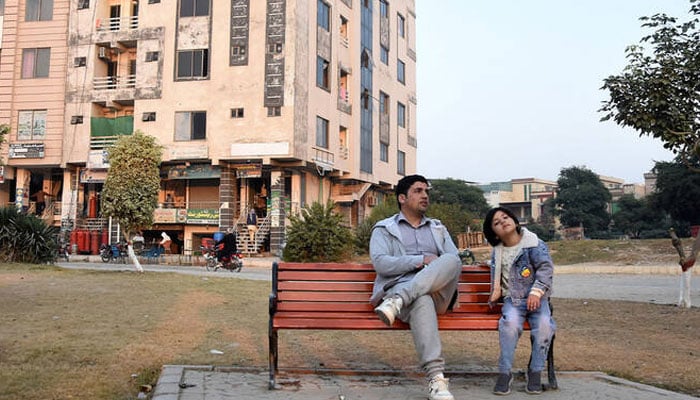 Ahmad Samim Naimi from Afghanistan’s Panjshir province, who had worked as a TV presenter and press adviser, sits with his daughter Arya Naimi (right) after the US halted visa processing for Afghan nationals, in Islamabad, Pakistan, on November 28, 2025. —Reuters