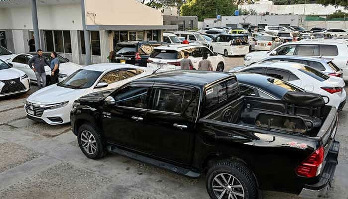 Vehicles are parked at a car dealers showroom in Karachi. — AFP/File