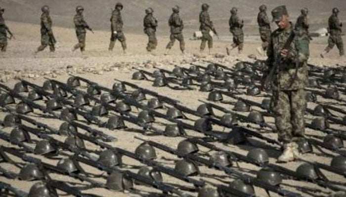 A soldier inspecting US weapons. —Radio Pakistan/File