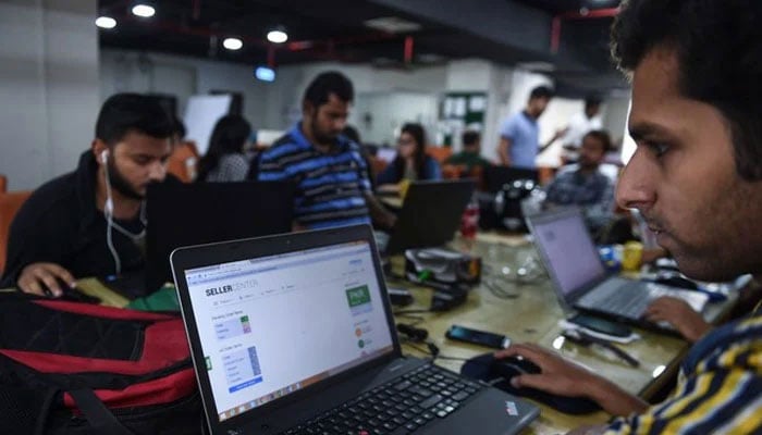 This photograph shows Pakistani employees of an online marketplace company in Karachi. — AFP/File