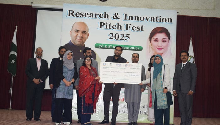 Participants pose for a photo while holding a cheque during the Research and Innovation Pitch Fest 2025, hosted by RWU on December 10, 2025. — Facebook@rawalpindiwomenuniversity