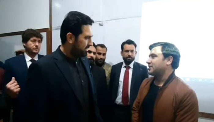 Chief Minister Muhammad Sohail Afridi (right) interacts with students during a visit to the Department of Economics at the University of Peshawar on December 11, 2025. — Screengrab via Facebook@KPChiefMinister