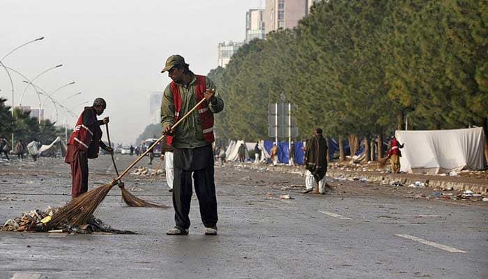 Representational image shows cleaners sweeping a street in Islamabad. — Reuters/File