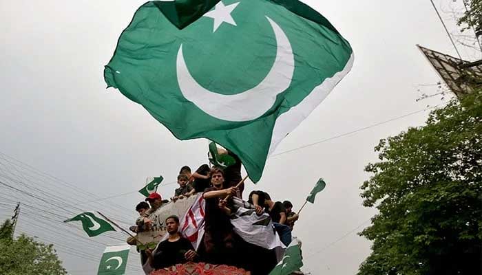 The representational image shows people waving flags as they rally in support of Pakistan Army, day after the ceasefire announcement between Pakistan and India in Lahore on May 11, 2025. — Reuters