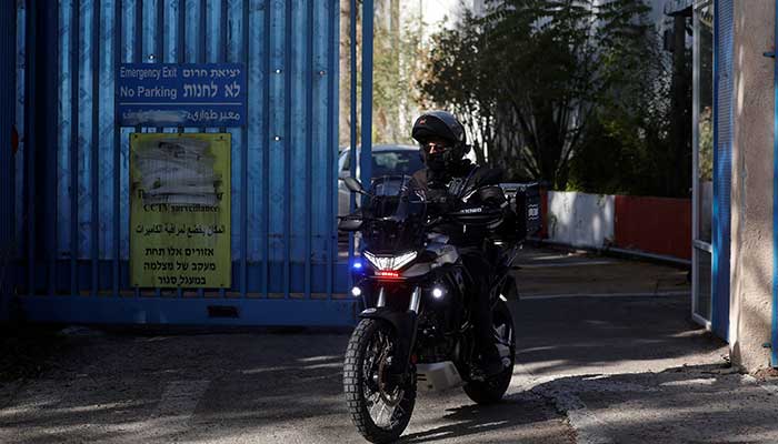 An Israeli police officer rides a bike while leaving the United Nations Relief and Works Agency for Palestine Refugees (UNRWA) headquarters, in Jerusalem December 8, 2025. — Reuters