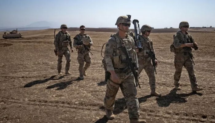 US soldiers walk during a joint military exercise between forces of the US-led “Combined Joint Task Force-Operation Inherent Resolve” coalition against ISIS and members of the Syrian Democratic Forces (SDF) in the countryside of the town of al-Malikiya (Derik in Kurdish) in Syria’s northeastern Hasaka province on September 7, 2022. —AFP