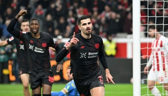 Bayer Leverkusen forward Martin Terrier celebrates after scoring his sides opener with a stunning backheel. — AFP