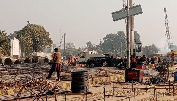 In this image, labourers are busy at a site of the Kachehri Chowk infrastructure project in Rawalpindi. — APP/File