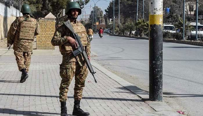 Pakistani army personnel stand guard along a road in Quetta on February 7, 2024. — AFP