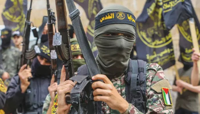 Members of the Ezz-Al Din Al-Qassam Brigades, the armed wing of the Palestinian Hamas movement, parade in Rafah in the southern Gaza Strip. — AFP