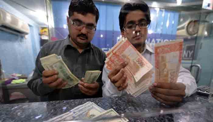 Forex dealers counting currency notes in this file photo.—TheNews/File