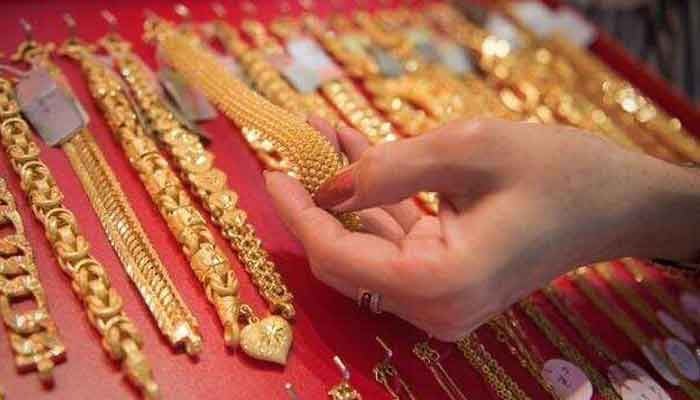 A customer examines a gold bracelet. — AFP/File