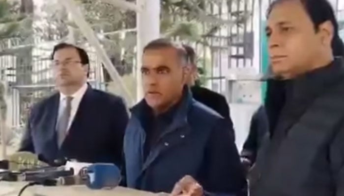 PMLN Senator-elect Abid Sher Ali (centre) talks to the media outside the Election Commission on December 18, 2025. — Screengrab via Facebook@ChAbidSherAli
