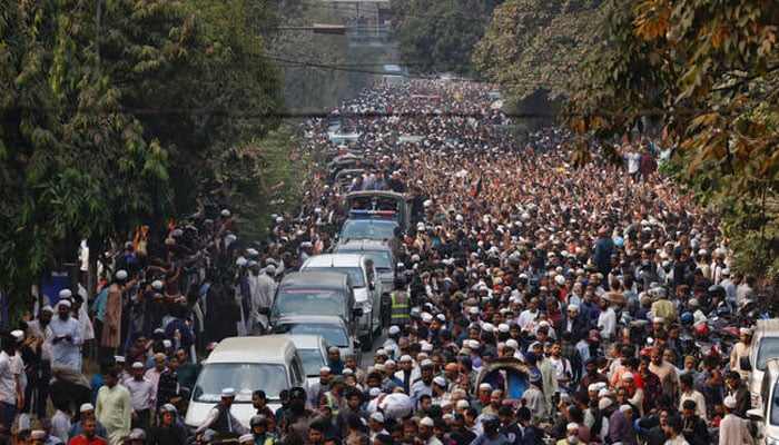 A convoy carrying the body of Sharif Osman Hadi, a student leader, who died after being shot in the head, moves along the crowd after the funeral prayer, in Dhaka, Bangladesh, December 20, 2025.—Reuters