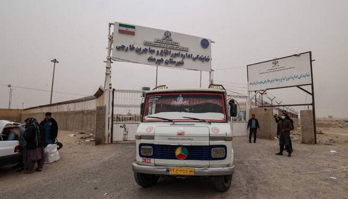 A bus carrying Afghan migrants who are being deported for reportedly failing to legalise their status in Iran leaves a camp at the Milak border crossing near the town of Zabol. —AFP/File