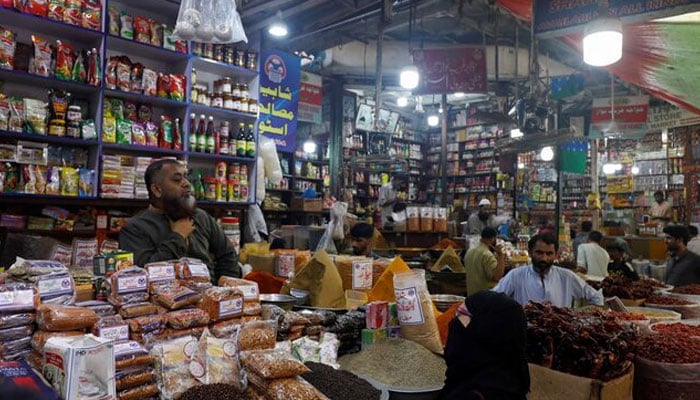 A customer speaks with a shopkeeper selling grocery items at a market in Karachi, Pakistan June 8, 2023.—Reuters