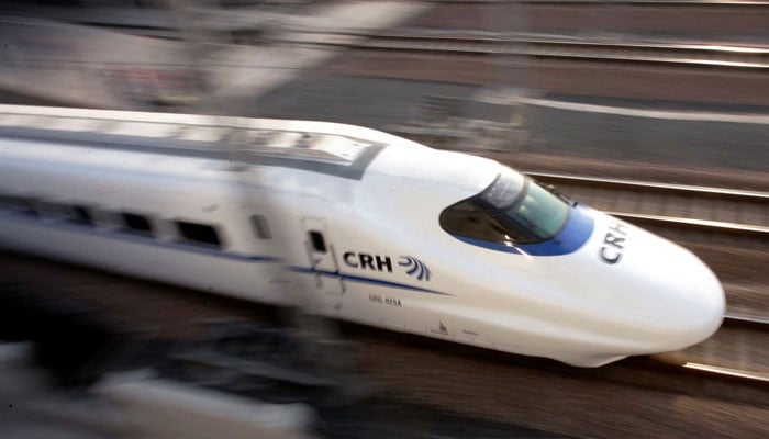 A bullet train speeds during its debut near a railway station in Shanghai January 28, 2007. — Reuters