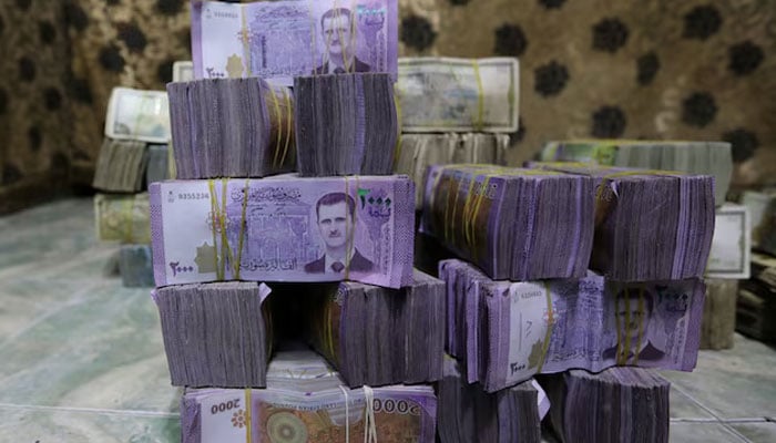 Stacks of Syrian pounds are pictured inside an exchange currency shop in Azaz, Syria February 3, 2020. Picture taken February 3, 2020.—Reuters