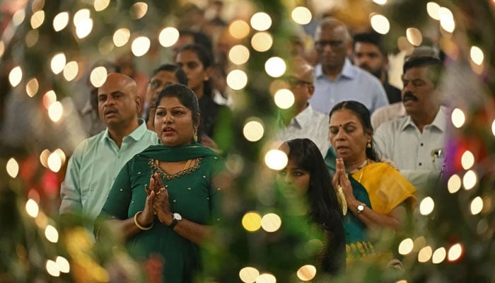 Devotees attend the Christmas mass in the Santhome Cathedral Basilica church in Chennai, India. —AFP/File
