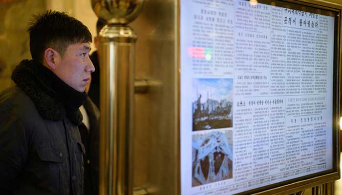 A man reads North Koreas Rodong Sinmun newspaper on a digital monitor at a metro station in Pyongyang. — AFP/File
