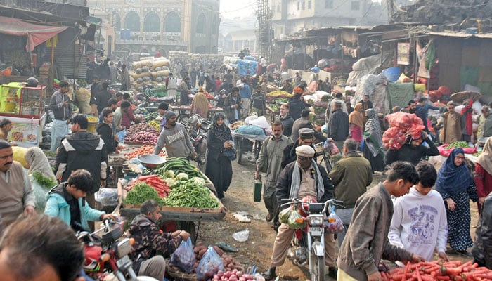 People are buying vegetables at a fruit and vegetable market in Lahore on December 28, 2025. —  Online