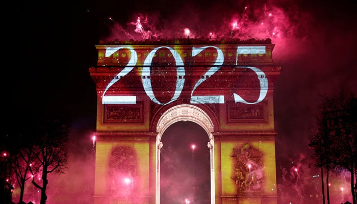 Fireworks explode as 2025 is projected onto The Arc de Triomphe during the New Years celebrations on the Champs Elysees avenue in Paris, France on January 1, 2025. — Reuters