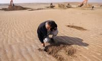 Iraqis Cover Soil With Clay To Curb Sandstorms