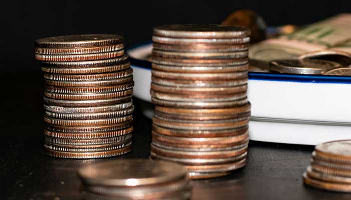 Representational image shows a pile of coins sitting on top of a table. — Unsplash/File