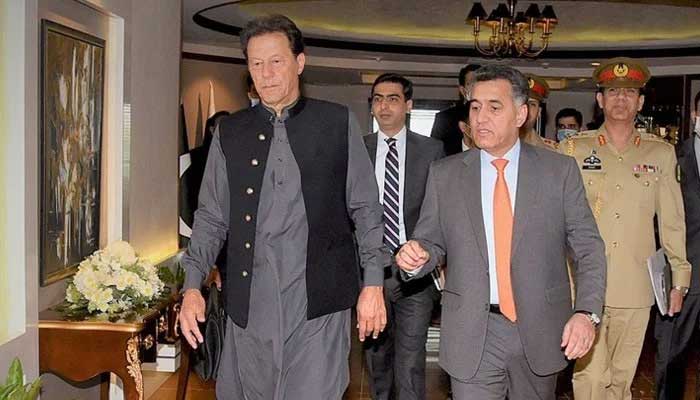 Former prime minister Imran Khan (left) walks along side ex-ISI chief Lt Gen Faiz Hamid. — PMs Office/File