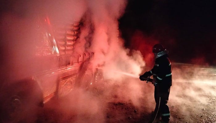 Firefighters try to extinguish a fire in a lorry loaded with cement bags in the Karmung Bala on January 5, 2025. — Facebook@Rescue 1122 Mansehra
