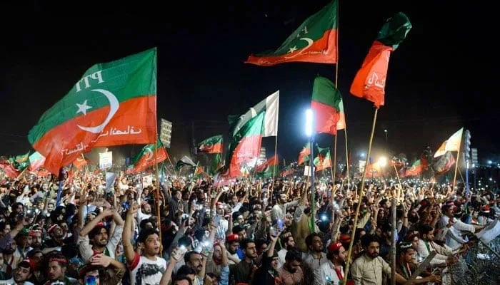 Pakistan Tehreek-e-Insaf (PTI) flags can be seen at the rally in this image. — AFP/File